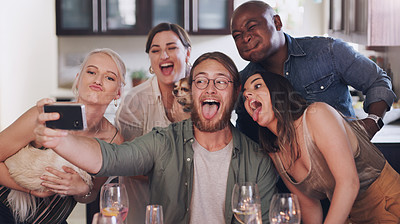 Buy stock photo Friends, selfie and silly pose during dinner party at home to celebrate new years eve together. Phone, photo and funny face diverse group of people posing for a mobile picture during lunch 