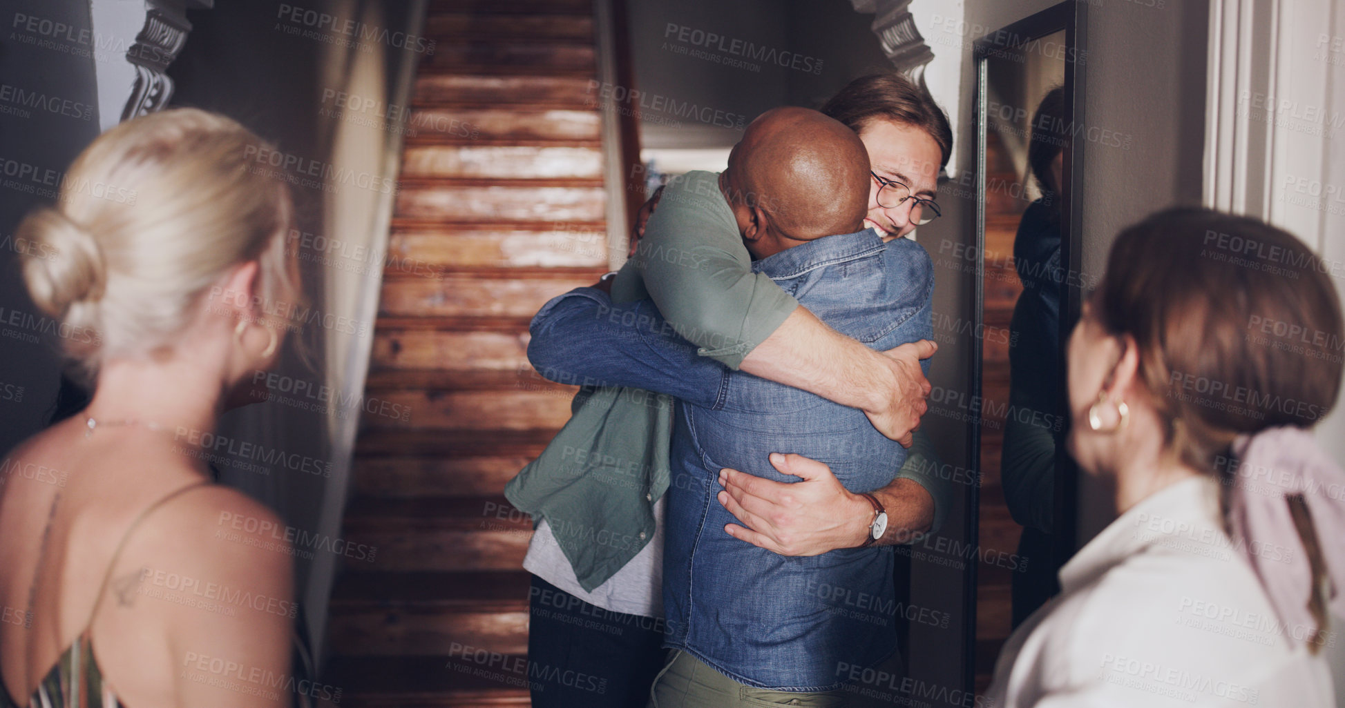 Buy stock photo Hug, love and friends meeting at a reunion, home support and social celebration at a housewarming. Diversity welcome, affection greeting and men and women hosting a party to celebrate friendship