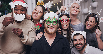 Buy stock photo Portrait of a group of young friends wearing funny hats and glasses at a Christmas party