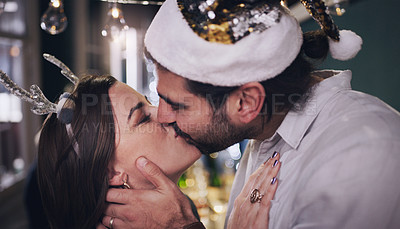 Buy stock photo Party, love and couple kiss at christmas house celebration for bonding, care and appreciation. Marriage, partner and holiday of young people kissing at festive event in home together.

