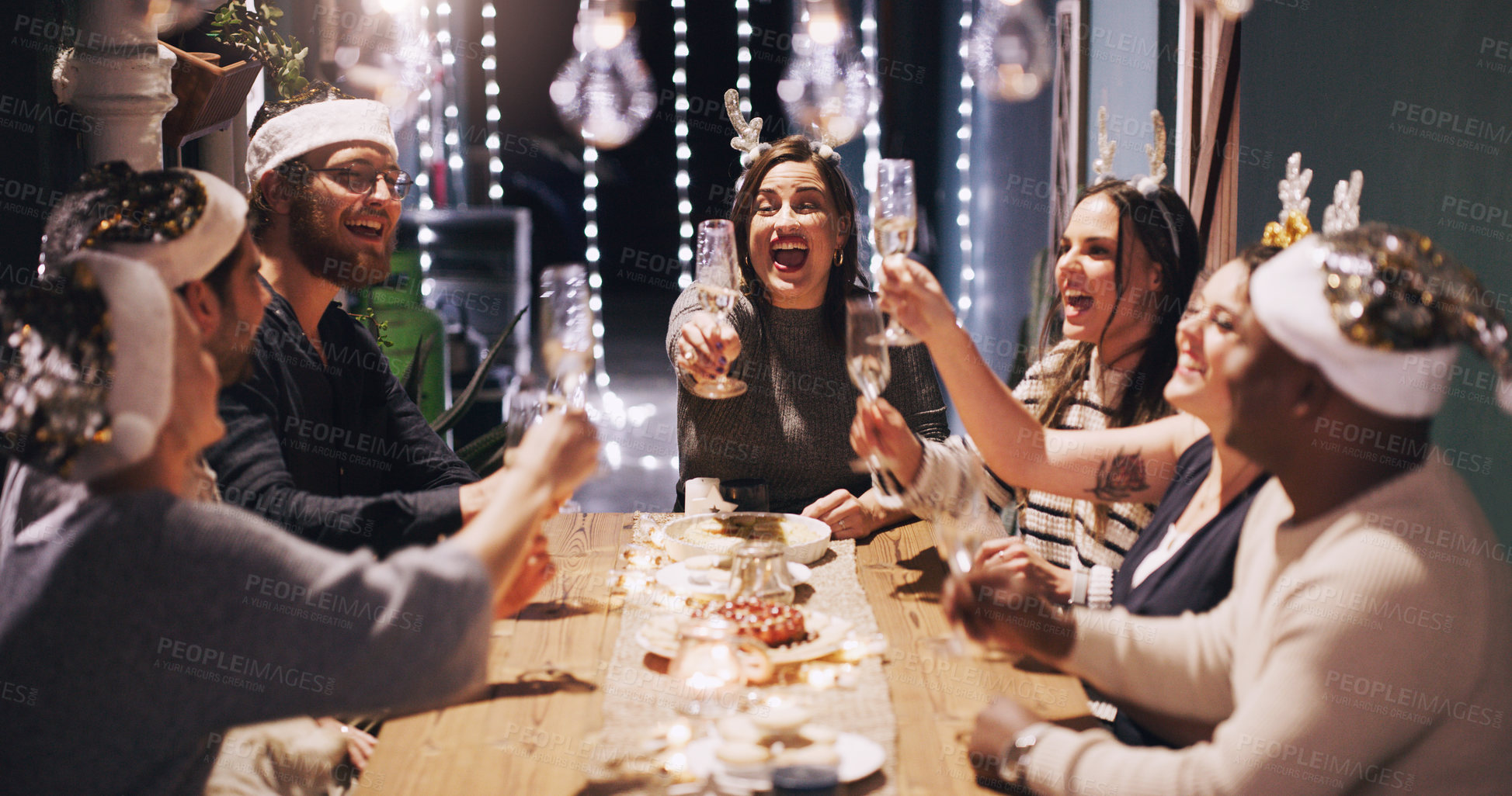 Buy stock photo Christmas, party and friends toast with champagne at dinner, lunch and festival celebration together. Social event, cheers and men and women with alcohol enjoy, holiday, vacation and dinner party