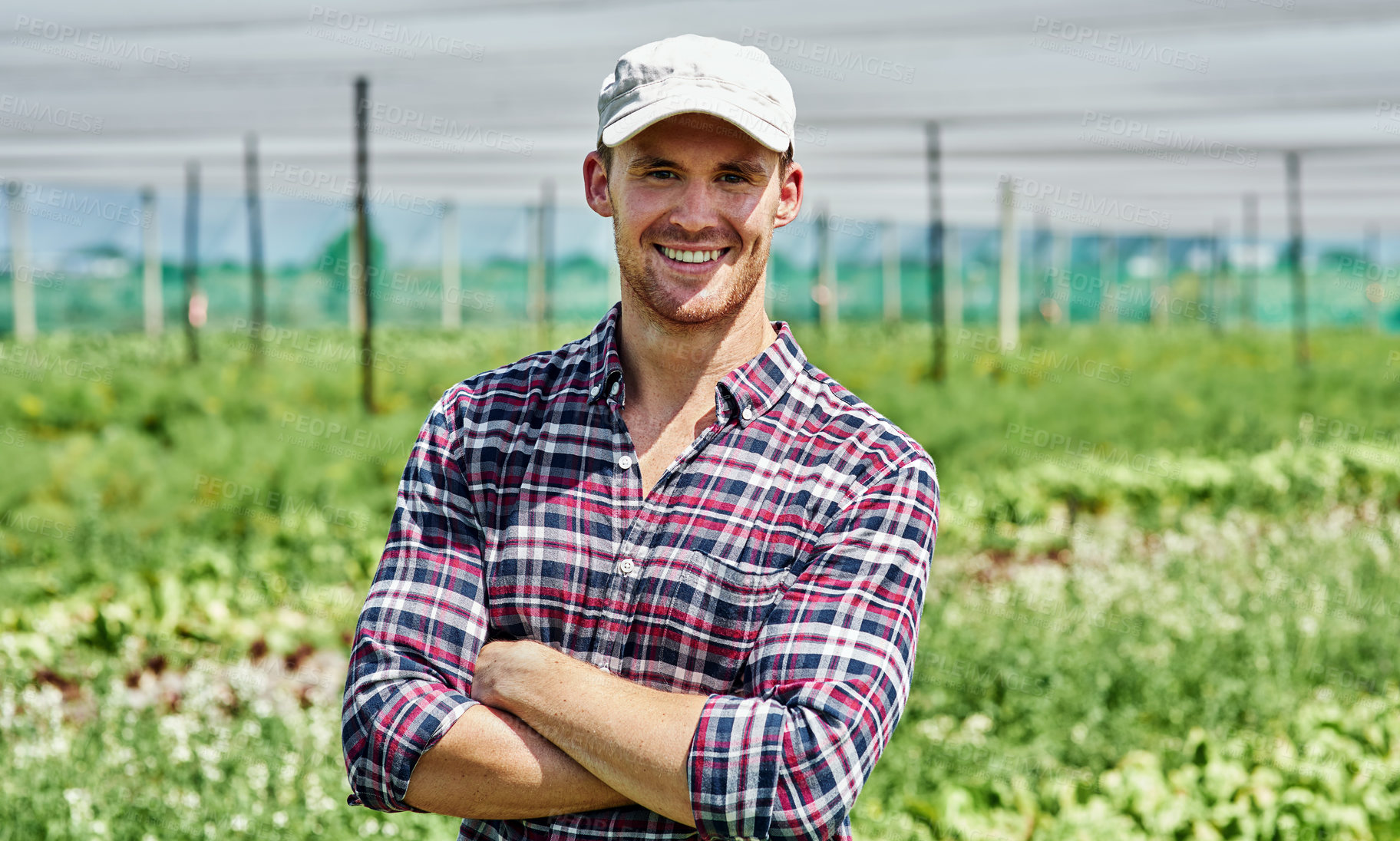 Buy stock photo Portrait of a handsome young farmer posing outdoors on his farm