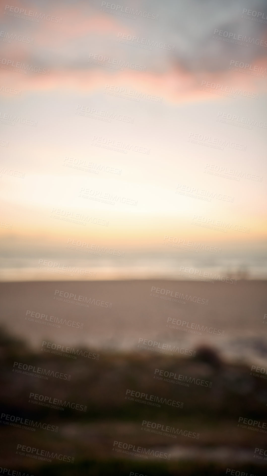 Buy stock photo Defocused shot of a beach at sunset