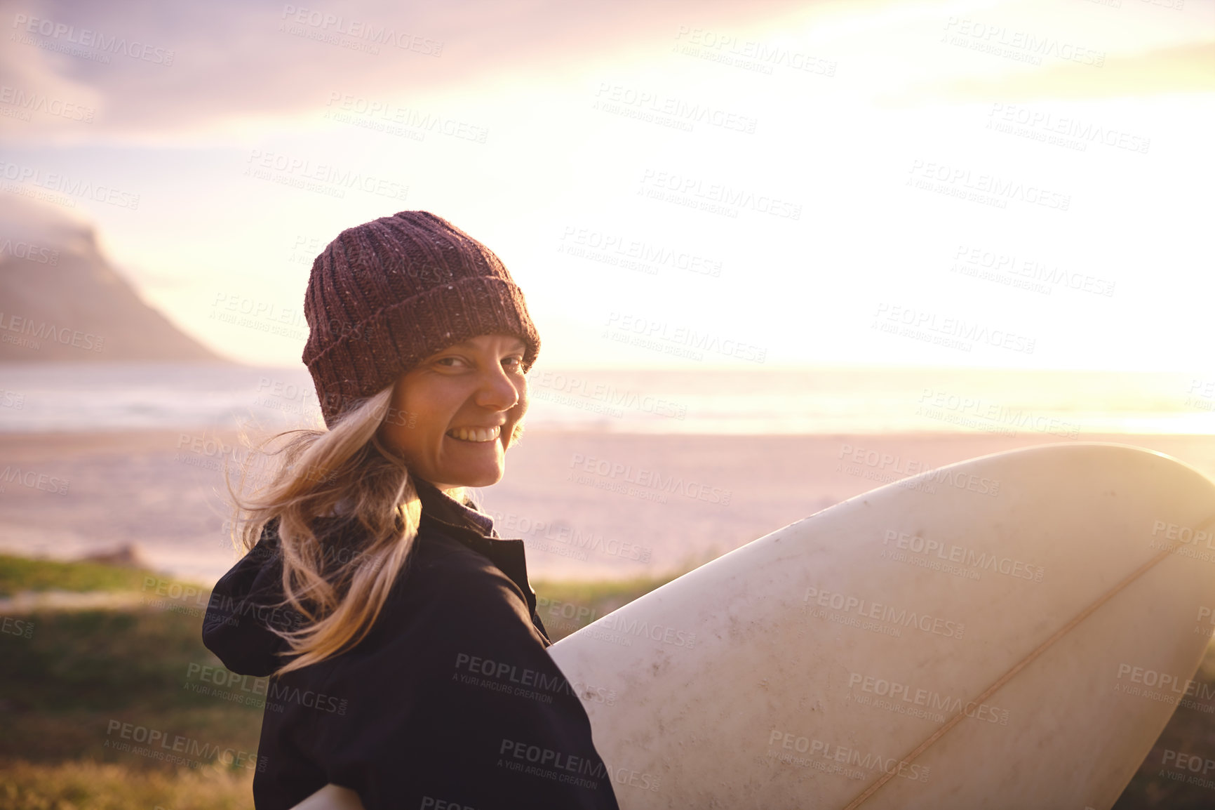 Buy stock photo Portrait, surfboard and woman by beach with sunset for winter vacation, adventure or holiday. Happy, surfing and female person on seaside weekend trip for outdoor watersports activity with travel.