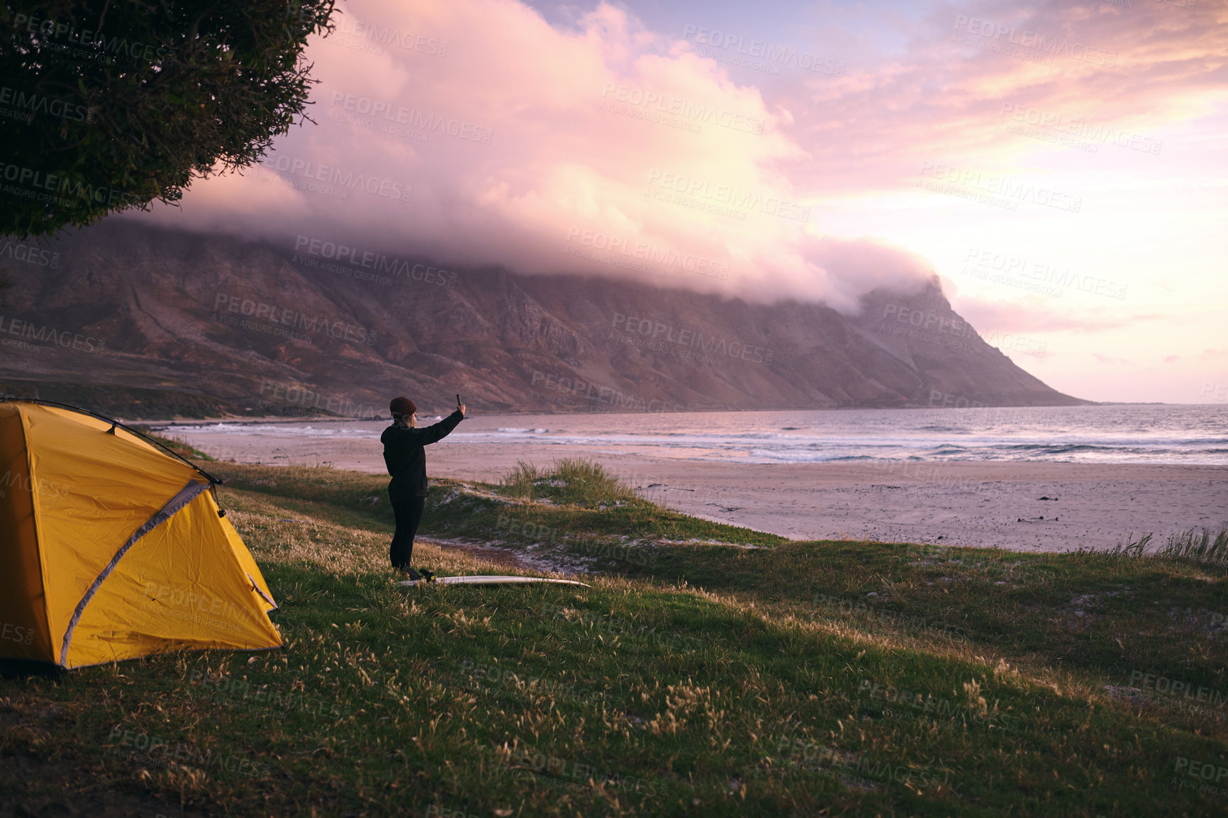 Buy stock photo Holiday, selfie and woman camp at beach in nature for travel, trip and memory on social media. Surfer, ocean and person at sea for picture with tent on adventure, vacation or sports outdoor at sunset