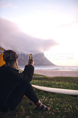 Buy stock photo Ocean, camping and woman with picture, photo and capture moment with adventure. Person, seaside and surfer with smartphone, journey and getaway trip with travel vlogger, sunrise and holiday with app