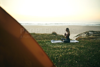 Buy stock photo Full length shot of an attractive young woman sitting alone and meditating during a relaxing day outdoors