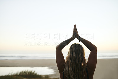 Buy stock photo Cropped shot of an unrecognizable woman standing alone and meditating during a relaxing day outdoors