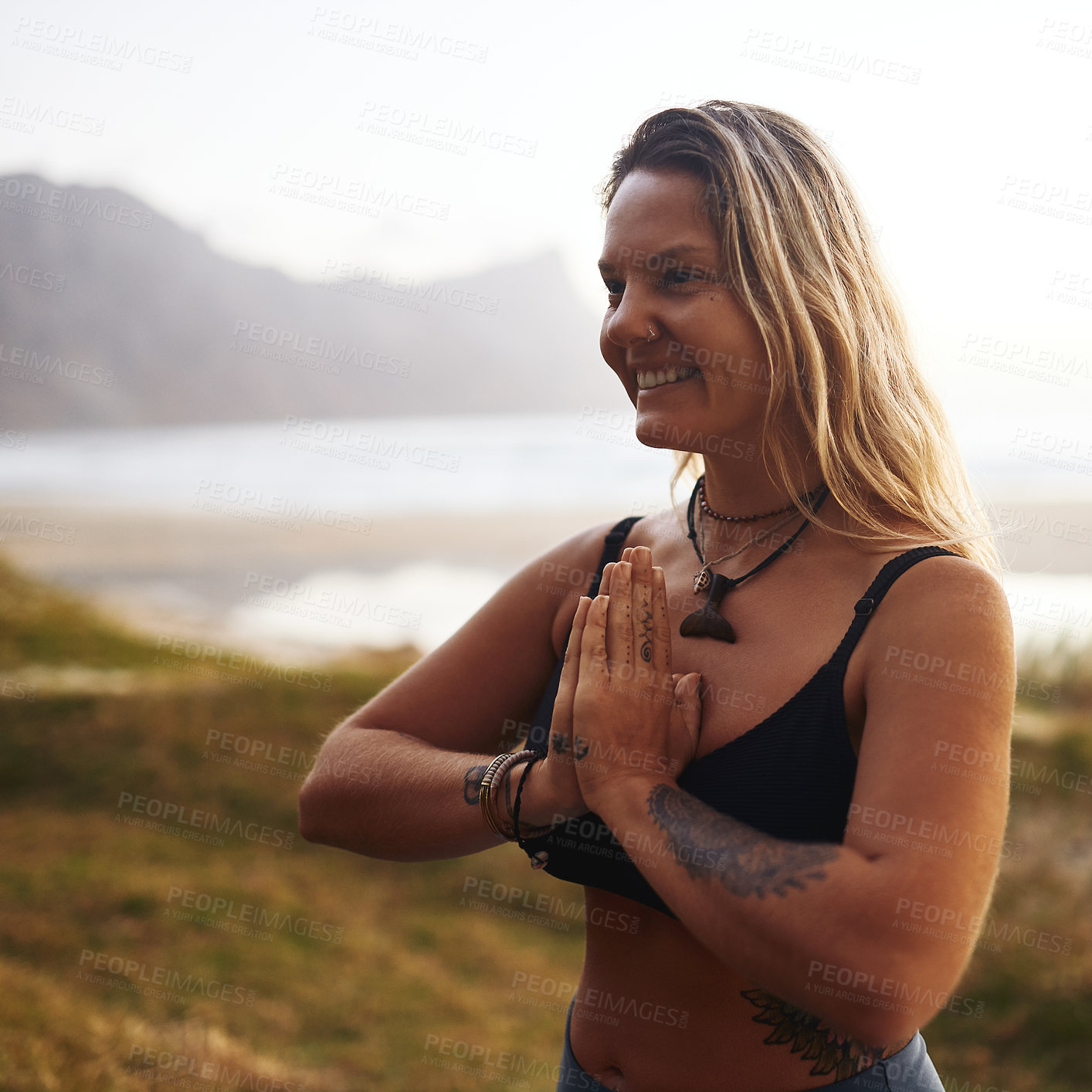 Buy stock photo Cropped shot of an attractive young woman standing alone and meditating during a relaxing day outdoors