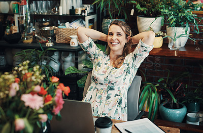 Buy stock photo Cropped portrait of an attractive young businesswoman sitting with her hands behind her head and feeling accomplished in her floristry