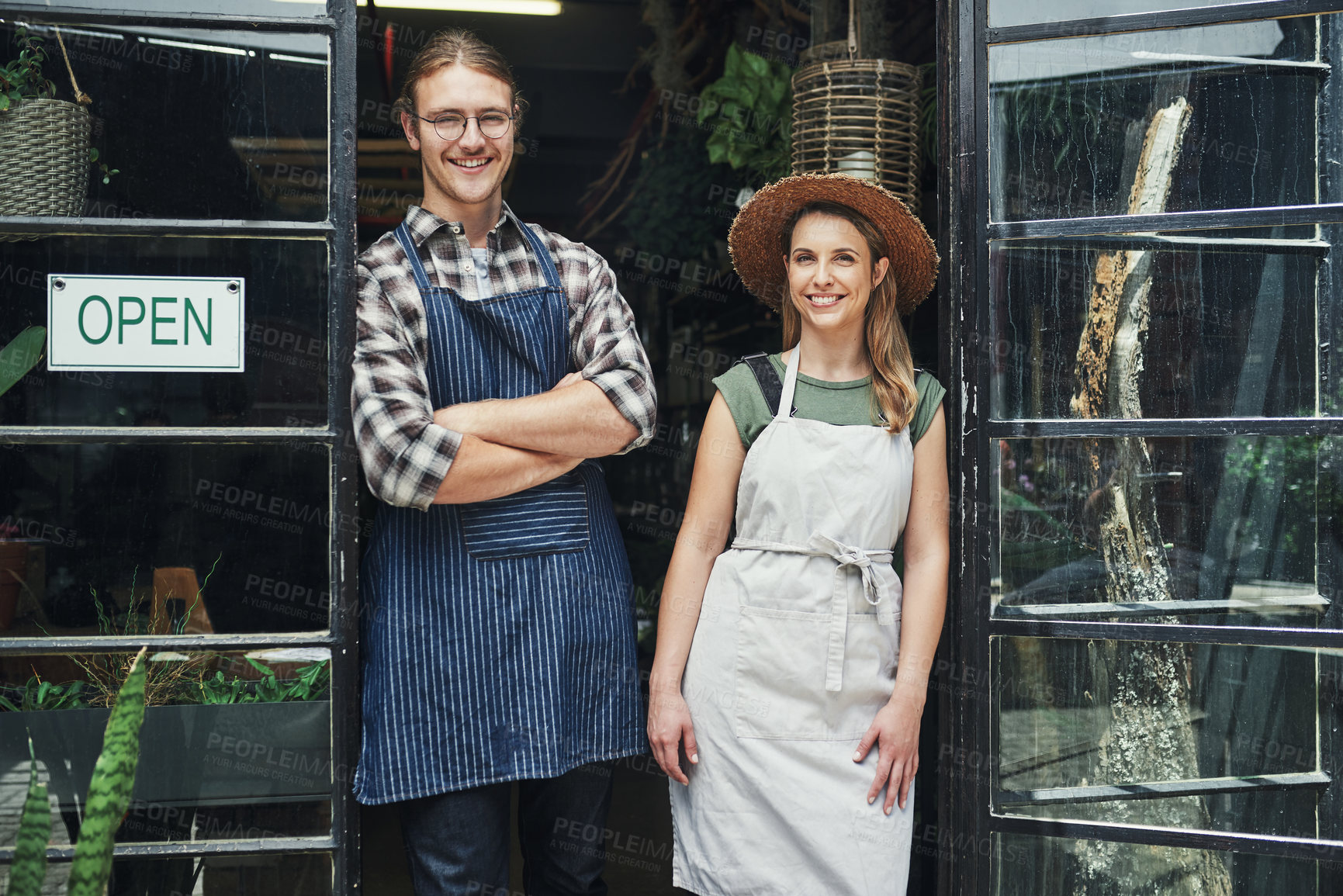 Buy stock photo Florist, partners and happy on portrait at door with open sign for small business operation in France. People, woman and man with smile or proud in confident for startup store and flower supply