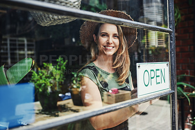 Buy stock photo Cropped portrait of an attractive young business owner standing alone at the entrance of her flower shop