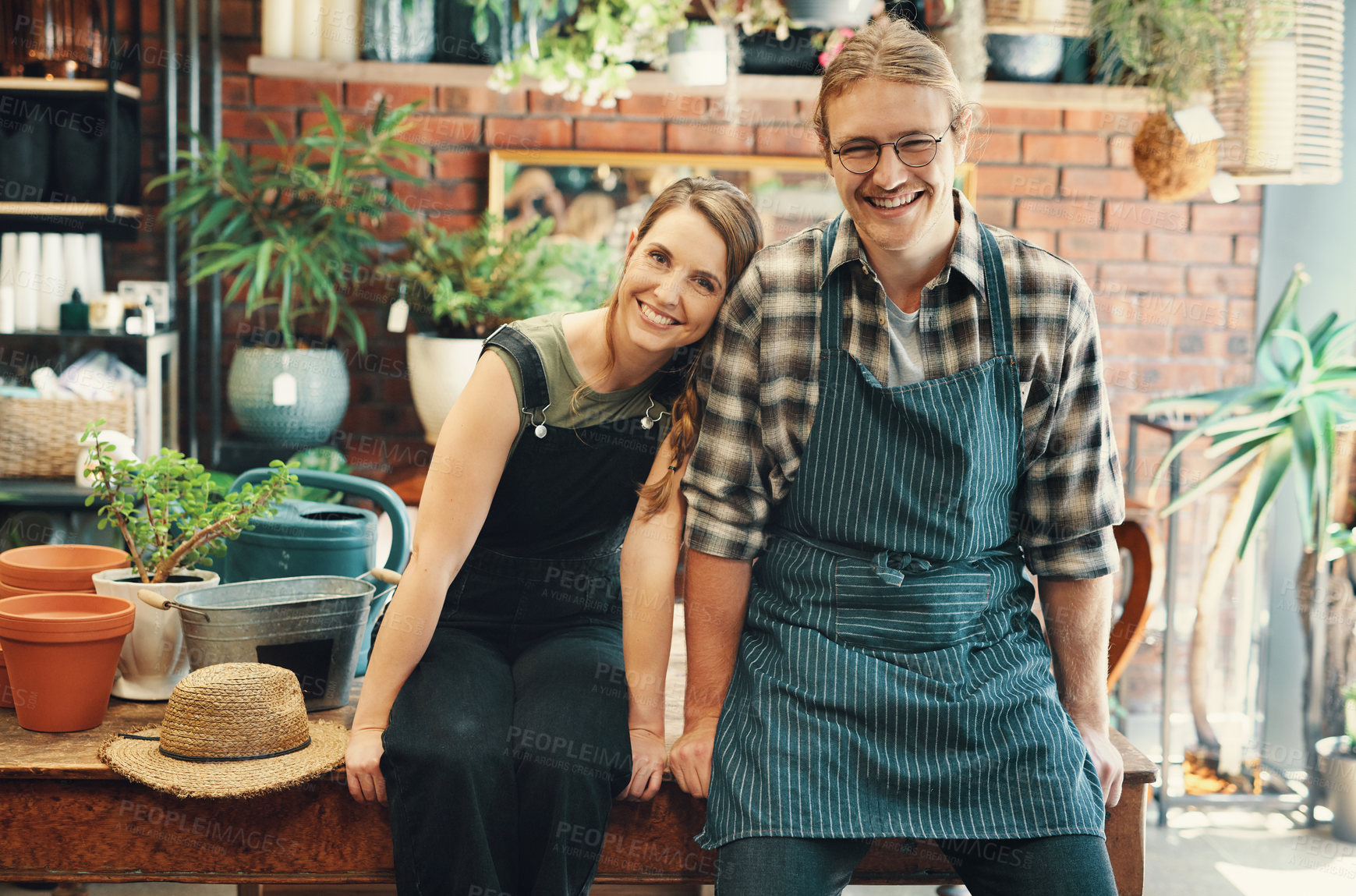 Buy stock photo Cropped portrait of two young business owners sitting in their floristry together during the day