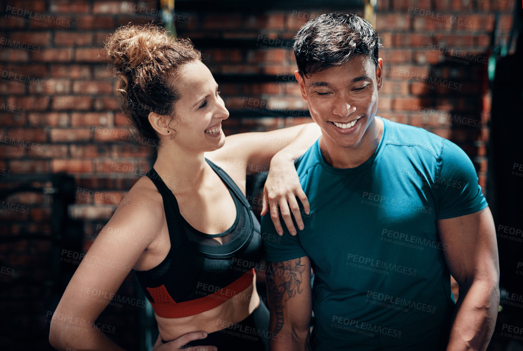 Buy stock photo Fitness, couple and happy for workout at gym with conversation, talking and exercise for healthy body. Personal trainer, partner and people with training break, relax and laughing in sports center