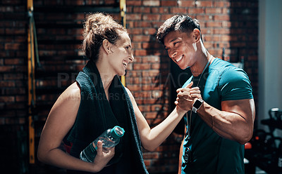 Buy stock photo Cropped shot of two cheerful young sportspeople cheering while working out in a gym