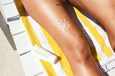 Buy stock photo Cropped shot of an unrecognizable woman wearing sunscreen while relaxing outside on a lounger