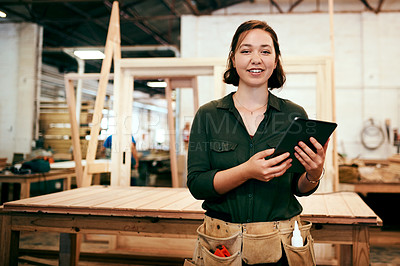 Buy stock photo Shot of a female carpenter using a digital tablet in her workshop