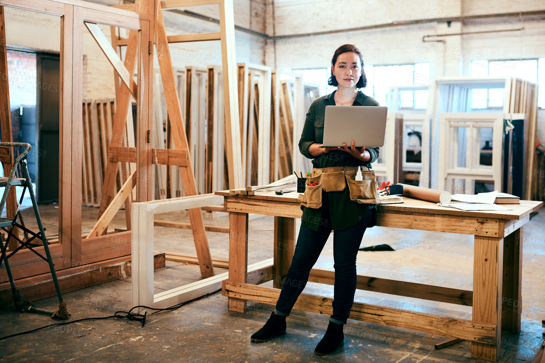 Buy stock photo Woman, portrait and carpenter with laptop for construction, maintenance and woodwork job. Workshop, manufacturing and online with wood, carpentry and tech for web order and creative building project