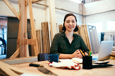 Buy stock photo Cropped shot of a female carpenter sitting at her desk in a workshop