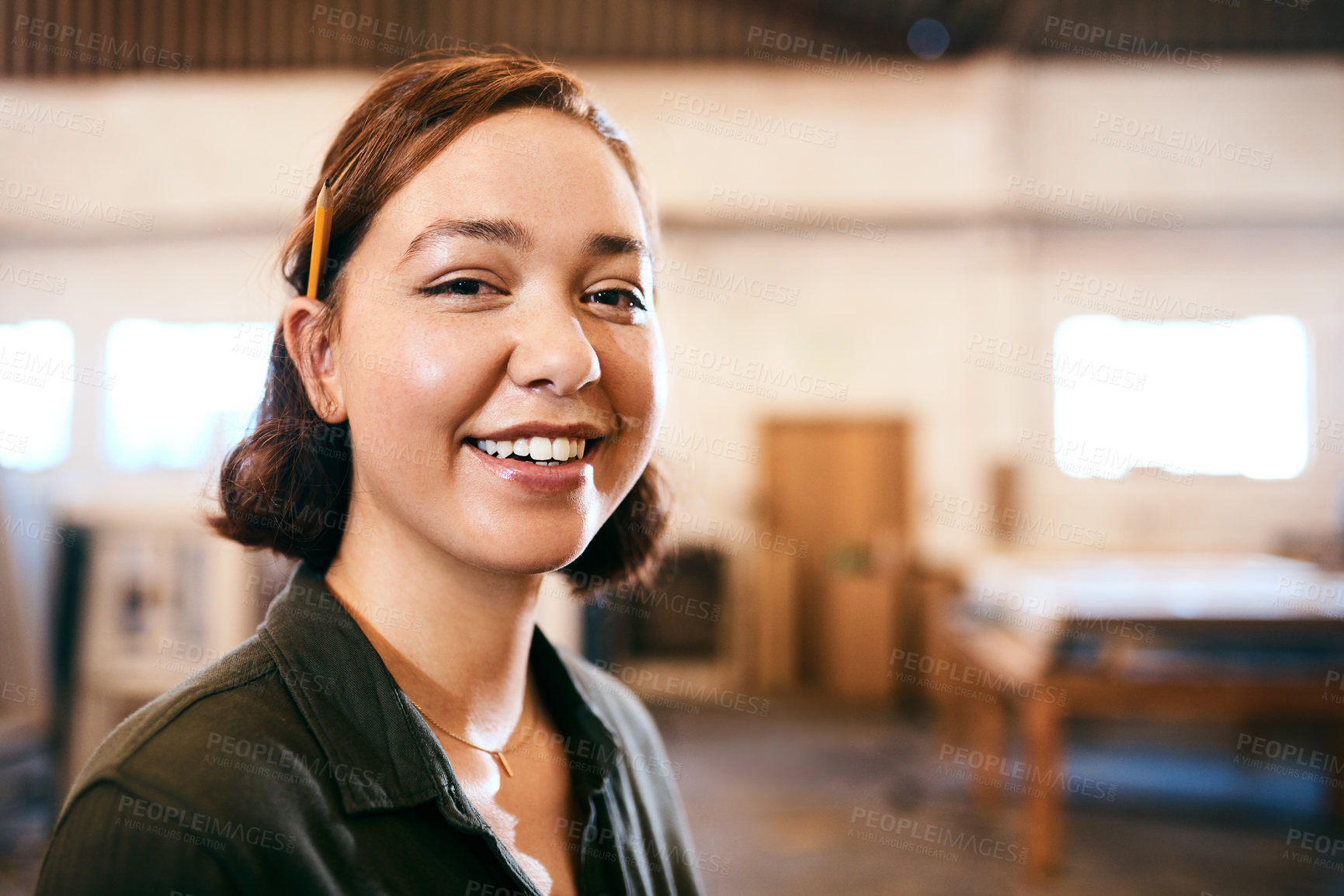 Buy stock photo Pencil, portrait and smile of carpenter woman in workshop for professional joinery or woodworking. Craftsmanship, creative and face of happy artisan in industrial warehouse for engineering design