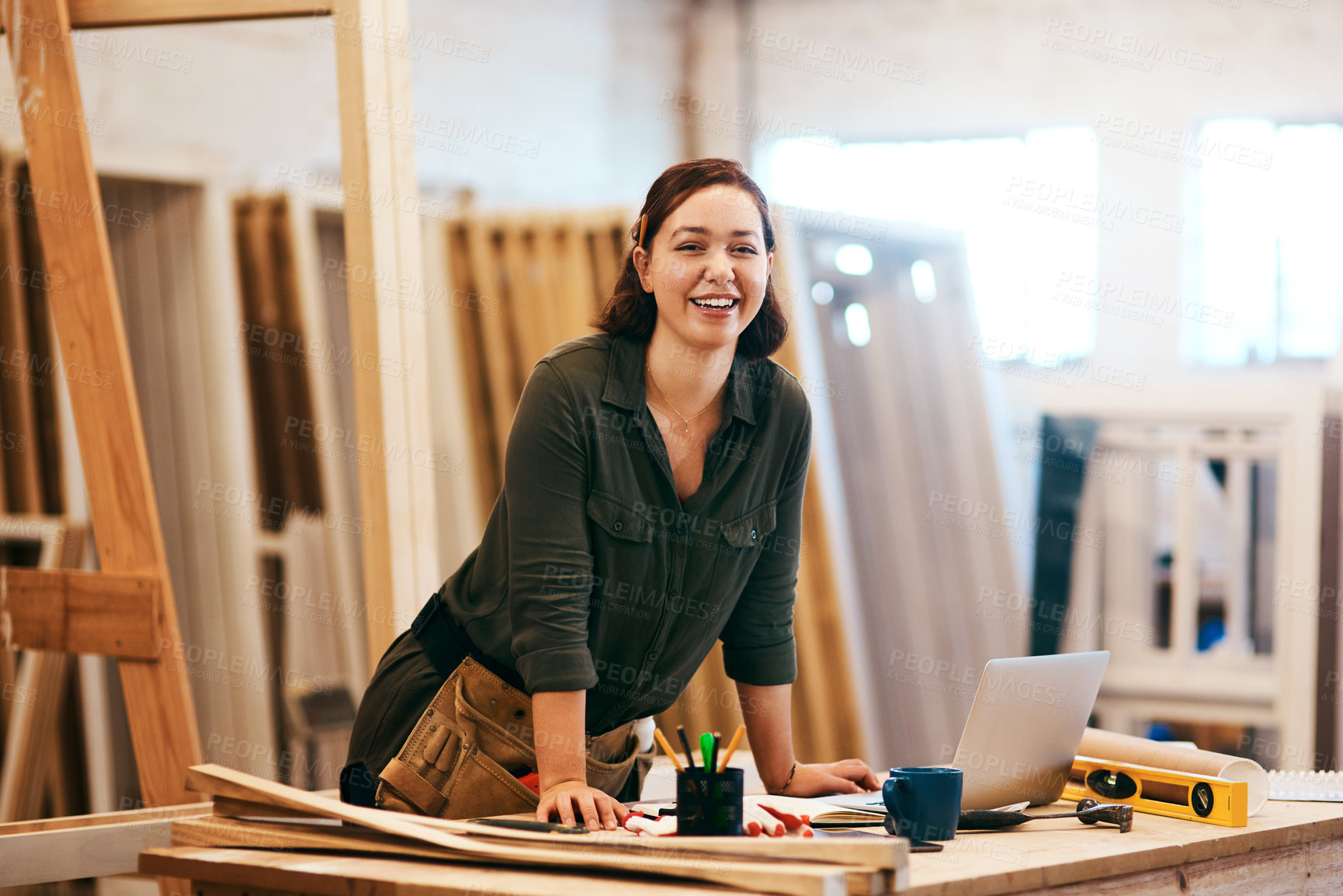 Buy stock photo Cropped shot of a young female carpenter smiling at the camera