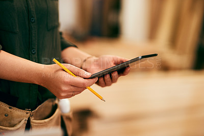 Buy stock photo Shot of a an unrecognizable carpenter using a digital tablet in her workshop