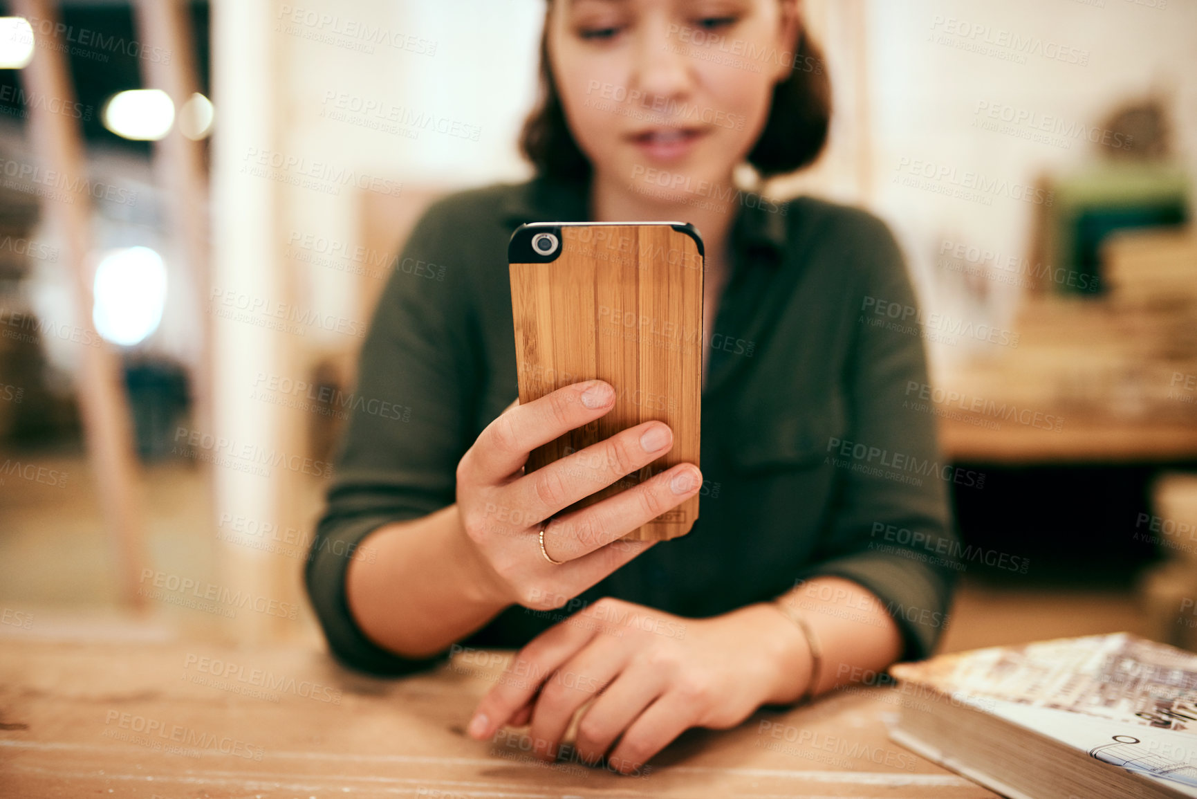 Buy stock photo Cropped shot of a female carpenter using her cellphone while sitting in her workshop
