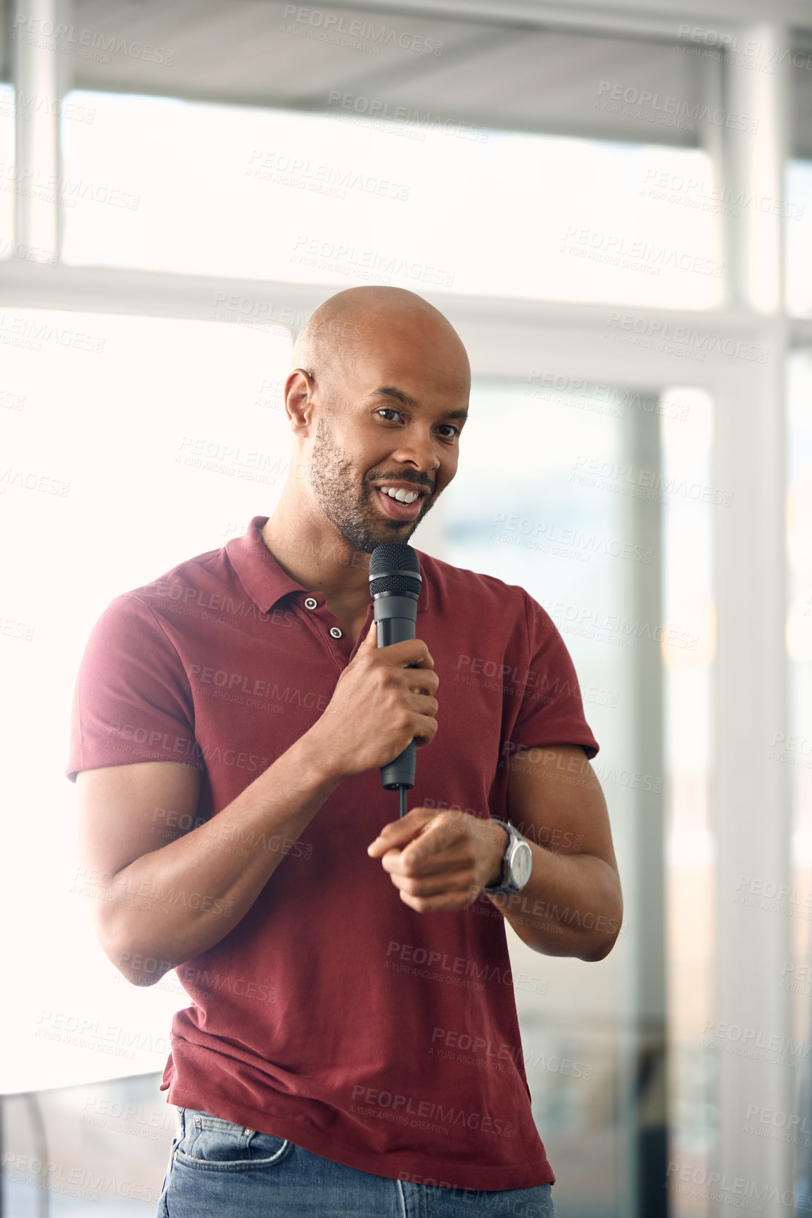 Buy stock photo Cropped shot of a handsome young man speaking over a microphone