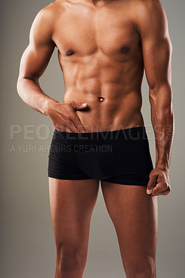 Buy stock photo Cropped shot of an unrecognizable muscular young man posing in underwear against a grey background