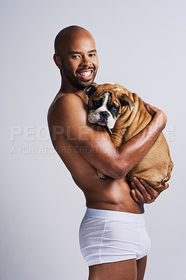 Buy stock photo Black man, hug and dog for portrait in studio with underwear, pet support and bonding for animal wellness. Male person, embracing and puppy with safety, loyalty and rescue friend on white background