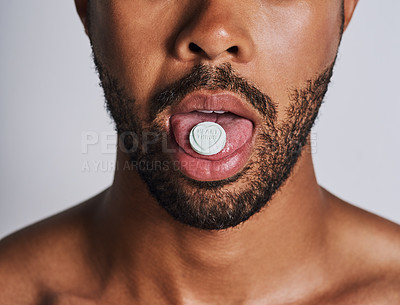 Buy stock photo Cropped shot of an an unrecognizable man taking medication against a grey background