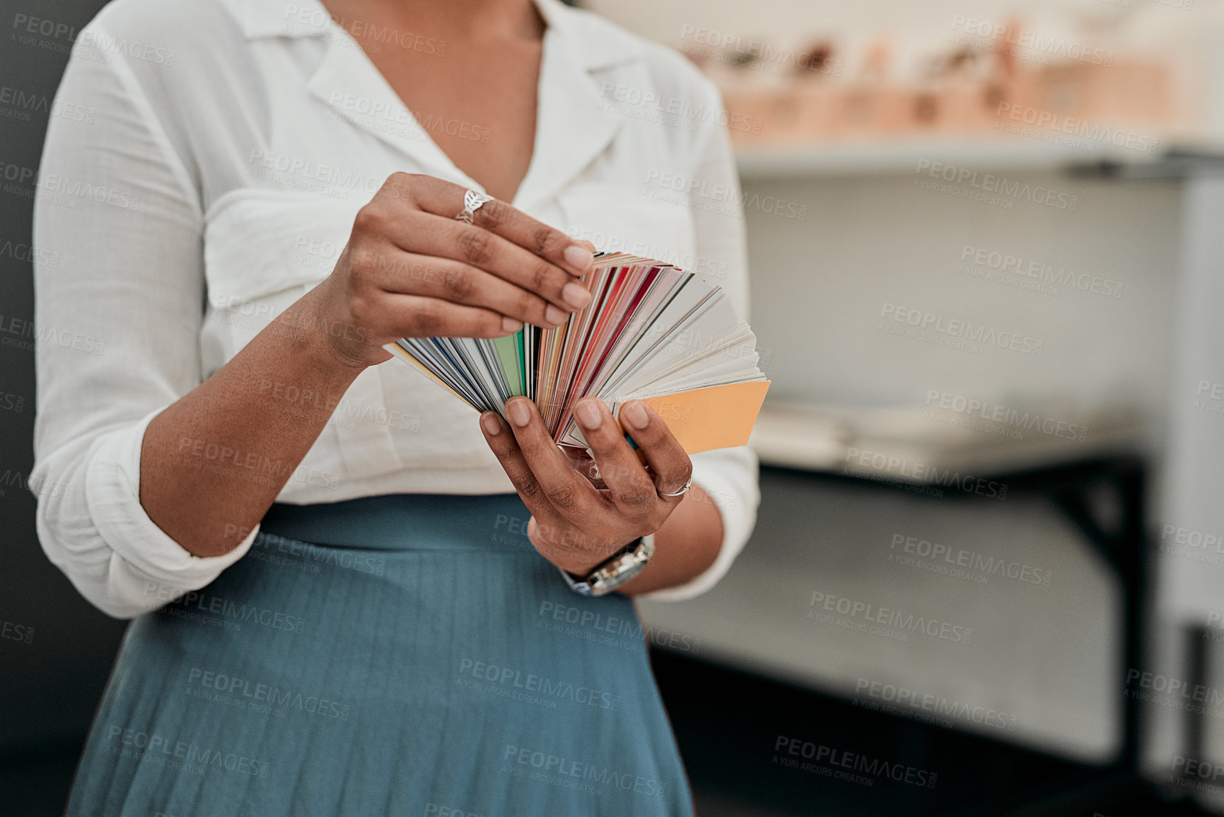 Buy stock photo Cropped shot of an unrecognizable architect looking at a color swatch while standing in her office