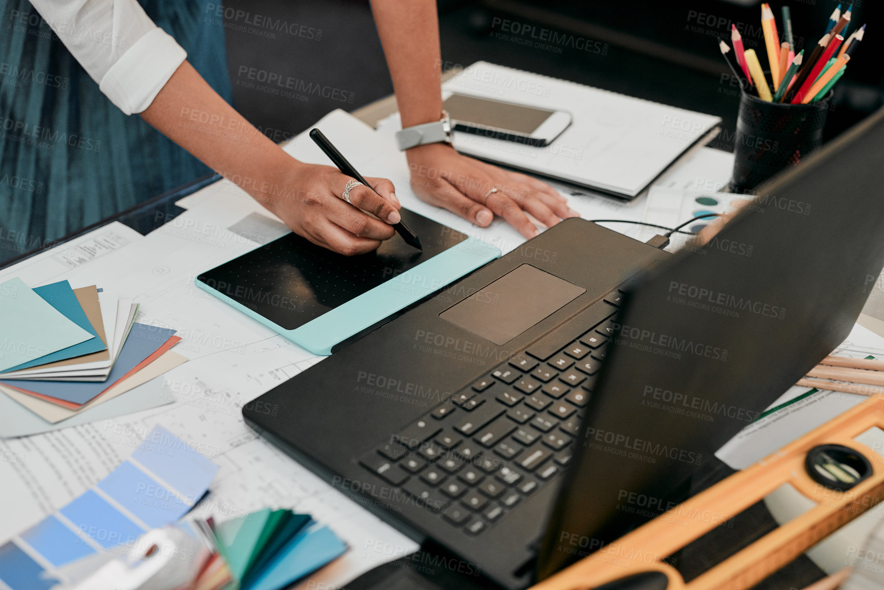 Buy stock photo Cropped shot of an unrecognizable designer working on her laptop