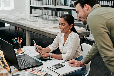 Buy stock photo Cropped shot of two young architects working together in a modern office