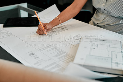 Buy stock photo Cropped shot of an unrecognizable architect working on blueprints