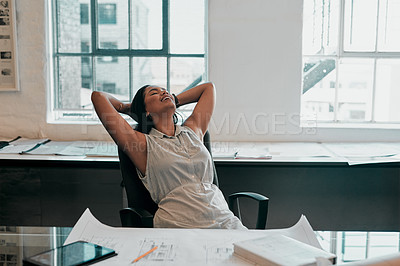 Buy stock photo Cropped shot of a female architect looking relaxed at her desk