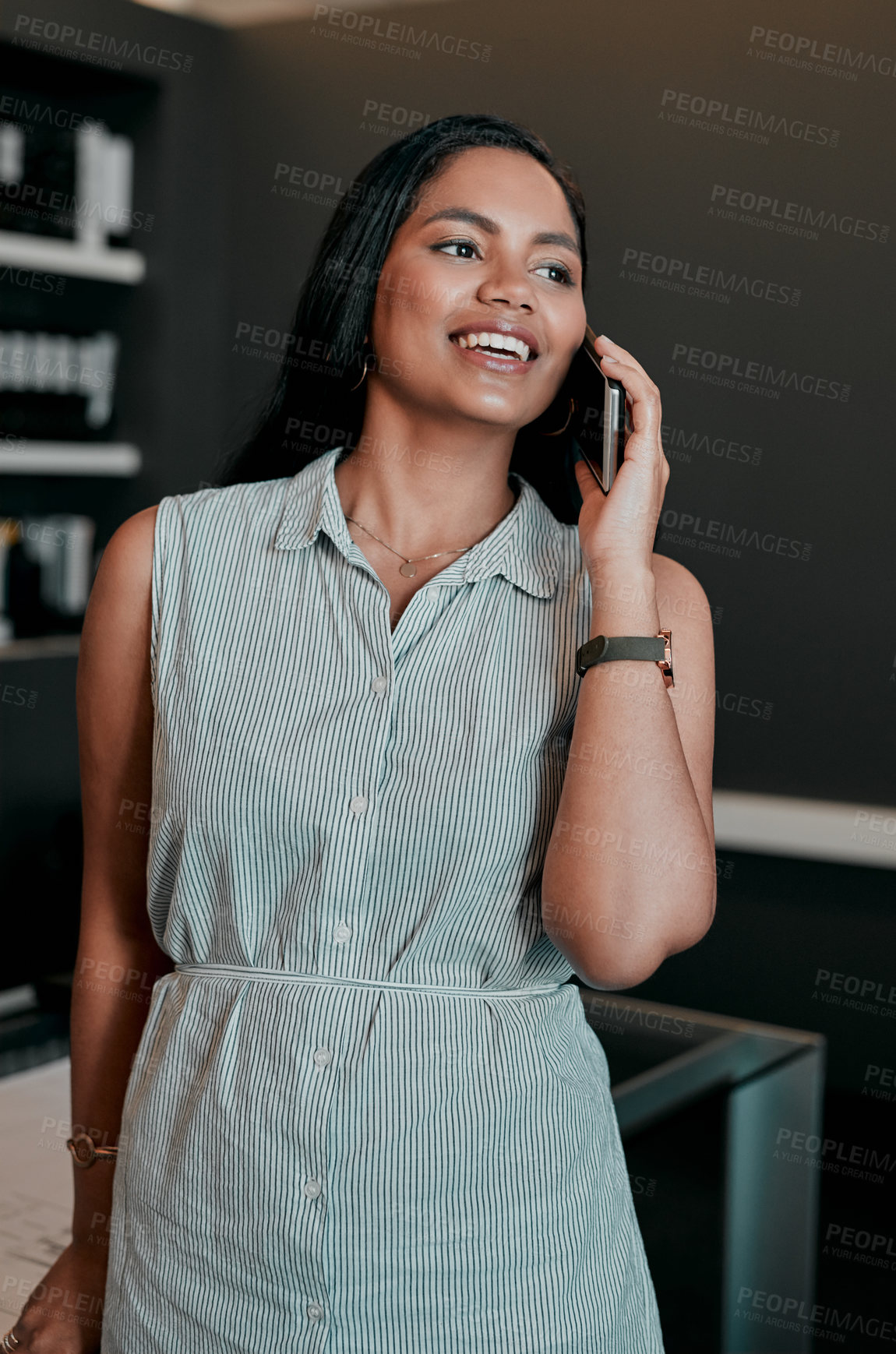 Buy stock photo Cropped shot of a young businesswoman talking on her cellphone