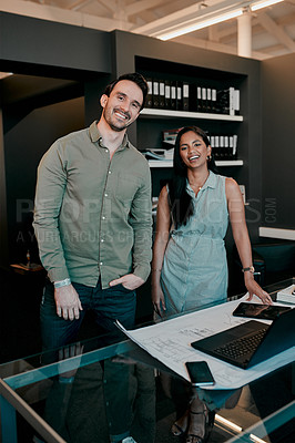 Buy stock photo Cropped shot of two young architects working together in a modern office