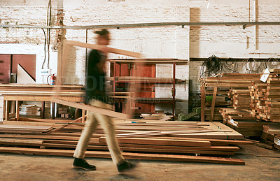 Buy stock photo Defocused shot of a young carpenter working inside a workshop