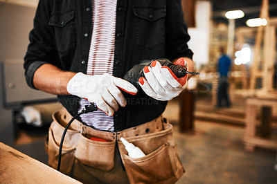 Buy stock photo Cropped shot of an unrecognizable carpenter holding an electric drill inside a workshop