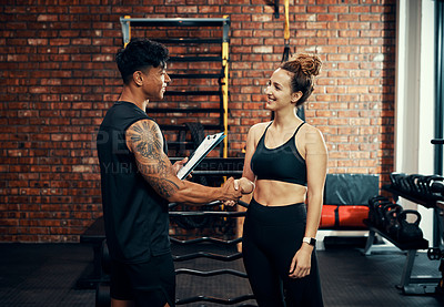 Buy stock photo Fitness training, woman and man with handshake, clipboard or contract for gym membership. People, instructor or workout with gesture, agreement or customer with documents, exercise or healthy routine