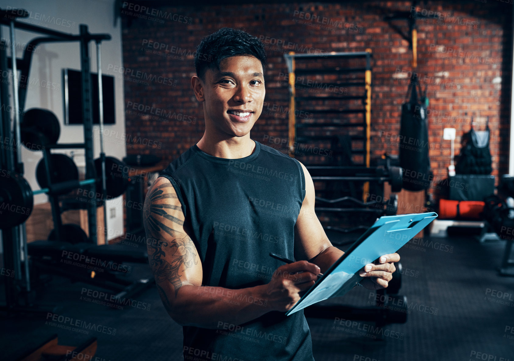 Buy stock photo Shot of a personal trainer holding a clipboard