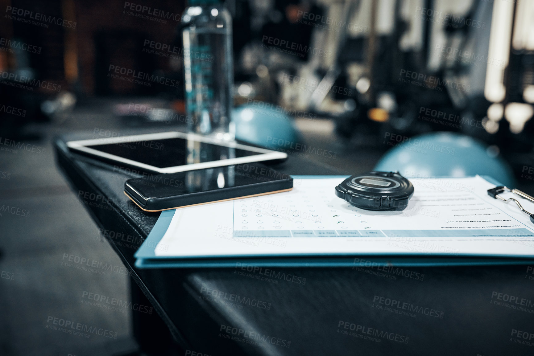 Buy stock photo Cropped shot of items lying on bench in a gym