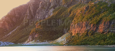 Buy stock photo Landscape view of lake water and mountains at sunset in Norway. Calm, serene, tranquil, ocean or sea at dawn in a remote, peaceful countryside. Relaxing nature fjord scenery with steep cliffs at dawn