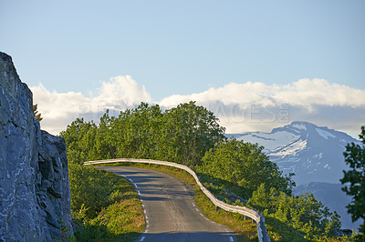 Buy stock photo Empty scenic road in mountains during summertime in Nordland. Secluded quiet and peaceful street on the countryside surrounded by lush green trees. Remote travel location in springtime with copyspace