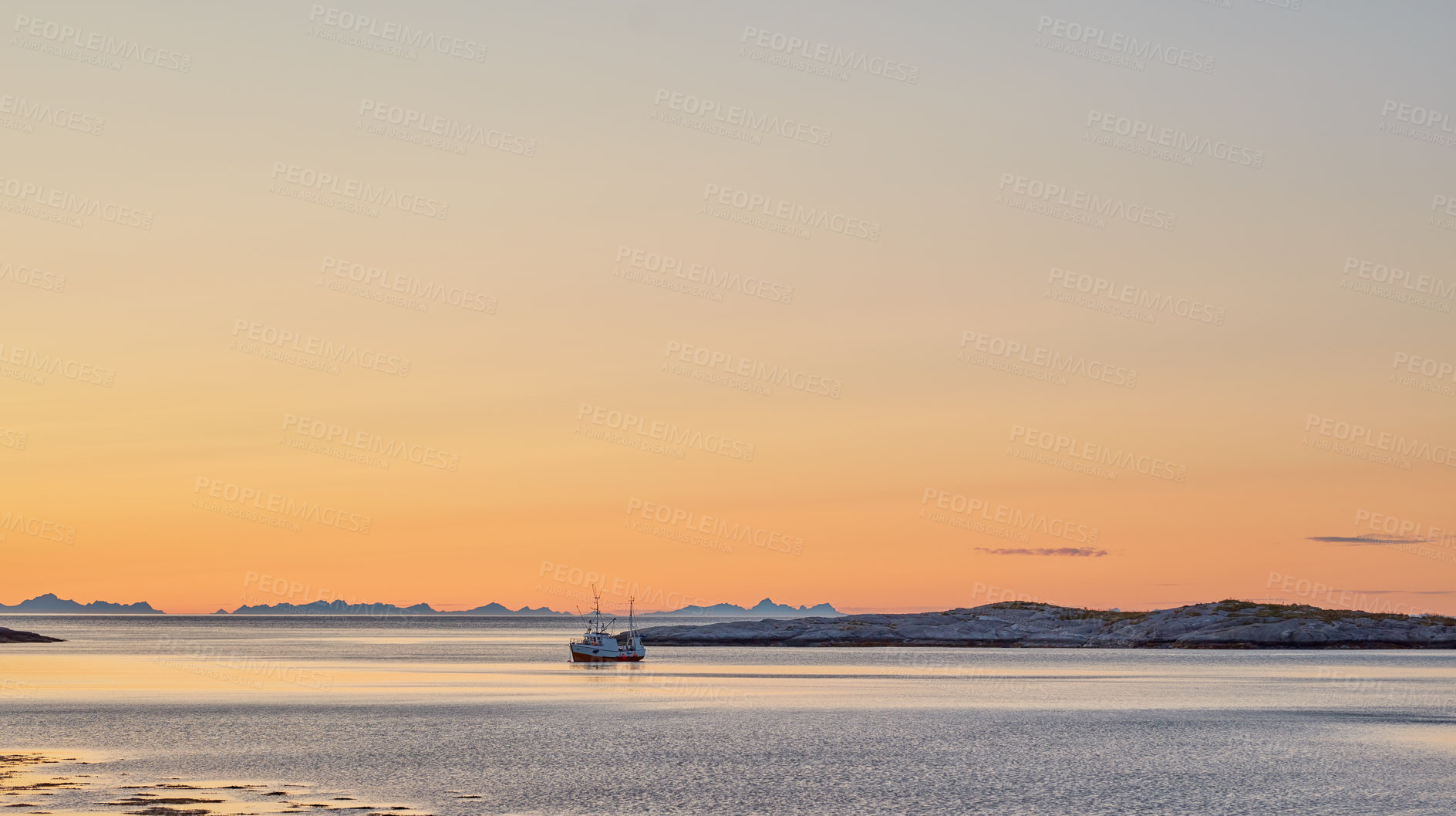 Buy stock photo Distant sailboat in the sea near a mountain in the water during sunset. The ocean, beach, or large lake with a marine vessel in the distance near a hill outdoors during dawn on a summer day in Norway