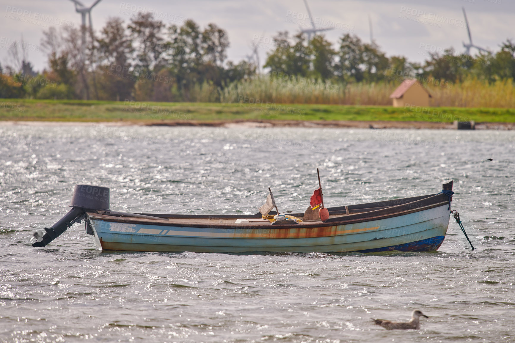 Buy stock photo Scenic view of a fishing rowing boat on a lake in remote countryside. A wooden nautical transport vessel with a motor used in the sea or ocean in Norway. Travel across peaceful bay of water or pond