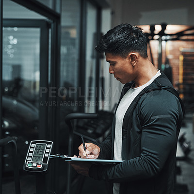 Buy stock photo Man, clipboard and writing notes in gym with equipment, check and inspection for maintenance. Person, checklist and paperwork for fitness, training and exercise with planning, profile and wellness