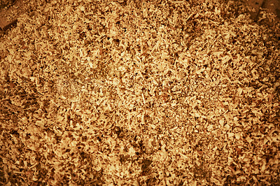 Buy stock photo High angle shot of wood shavings on the floor inside a carpentry workshop