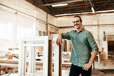 Buy stock photo Portrait of a happy young carpenter posing inside a workshop